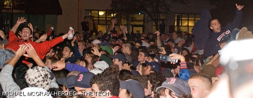 Two young men crowd surf. The Boston Red Sox defeated the Colorado Rockies 4-3 on Sunday night, claiming their second World Series win in the past four seasons.