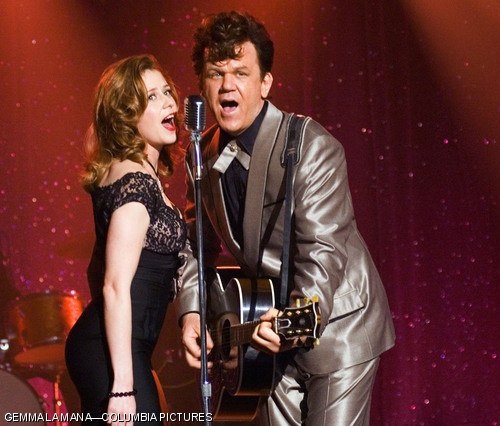 Jenna Fischer (left) stars as Darlene Madison and John C. Reilly stars as Dewey Cox in the comedy “Walk Hard: The Dewey Cox Story.”