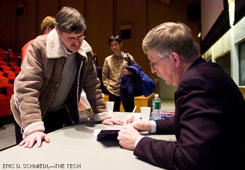Francis Collins signs a copy of his book for attendee David Hempton after giving a lecture on DNA as the language of God. The Veritas Forum, which organized the talk, will be sponsoring additional lectures today and tomorrow.