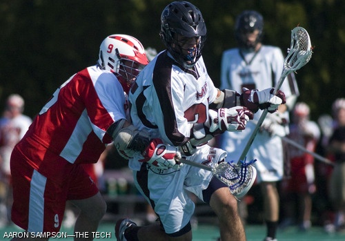 John R. Kucharczyk ’11 breaks away from Clark University’s Nate Sherman during the closing minutes of the men’s lacrosse team’s 9-5 defeat over the Cougars on Saturday.