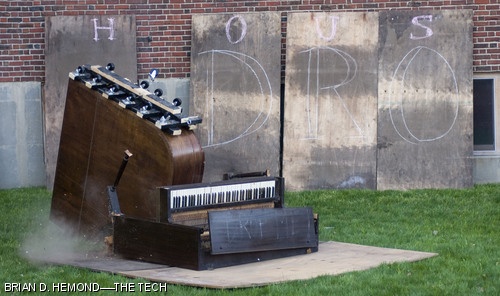 A grand piano, donated to Baker House by the Delta Kappa Epsilon fraternity for destruction in the annual Piano Drop, slams into a second target piano laying on the ground outside the dorm on Thursday, April 24. The Piano Drop is held every spring on Drop Date.