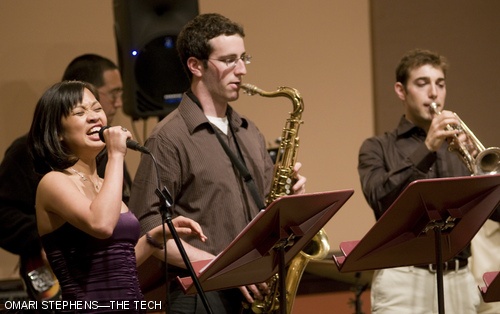 The so-called 7:30 and 5:30 Jazz Combos played a joint end-of-semester concert last Tuesday, April 29 in Killian Hall. Here, Sheena C. Hembrador ’06 belts out the vocals in Stevie Wonder’s “Superstition” as (left to right) ensemble coach A. Keala Kaumeheiwa (obscured) plays electric guitar, Daniel R. Hochbaum ’10 plays saxophone, and Aaron J. Schmidt G plays trumpet.