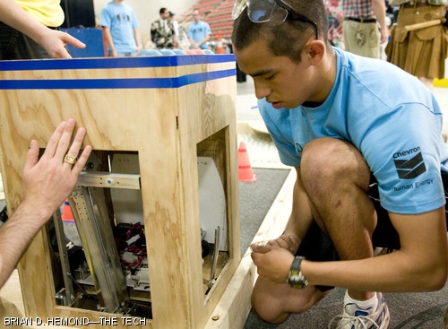 Ethan L. Huwe ’10 tries unsuccessfully to extract his robot from the clutches of his opponent’s “bother bot,” a small robot designed to rapidly cross the competition field and jam its opponent’s movement. The annual 2.007 competition, this year entitled “Da(yes)MIT” or “Save the Baby Beavers,” was held last Wednesday and Thursday, May 7 and 8, in the Johnson Athletic Center.