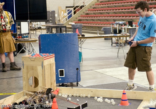 A robot built by Radu Gogoana ’10 pulls back the barrier containing the “food” pellets and diverts the flow of falling balls into the starting box. The annual 2.007 competition, this year entitled “Da(yes)MIT” or “Save the Baby Beavers,” was held last Wednesday and Thursday, May 7 and 8, in the Johnson Athletic Center.