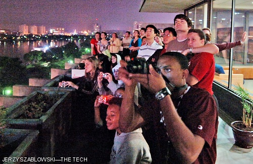 MIT students and friends watch the fireworks display from the penthouse of McCormick Hall on July 4.