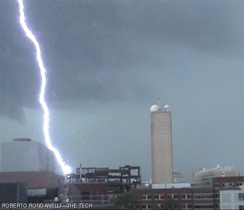 A video still shows lightning striking a crane at the Media Lab Extension construction site, as seen from Eastgate Apartments on June 27.