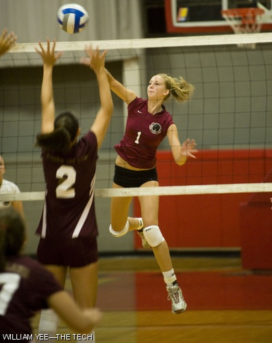Kelly E. Schulte ’12 leaps up for a kill in front of a Rhode Island College player in the pre-season game on Wednesday, Sept. 3.