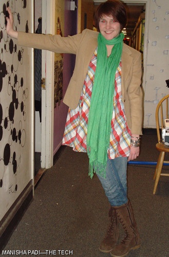 Tess E. Wise ’10 is wearing her grandmother’s jacket, a scarf from a street vendor in Brussels ($5), boots from Riverwoods ($70), a plaid dress from H&M ($15), jeans from TJ Maxx ($30), and bracelets from Bass ($10). Why we like it: The layering and weather-friendly shoes make this a practical outfit, while the bold prints and colors are eye-catching.