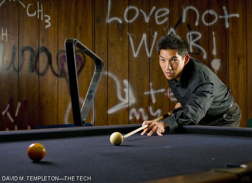 Timothy E. Chin G shows off his skills at the pool table. Chin is one of the top pool trick shot artists in the world.