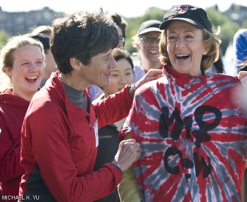 MIT President Susan J. Hockfield is presented with a tie-dye style T-shirt from members of the crew team as part of the Crew Alumni Association’s boat dedication at the Boathouse on Saturday morning.