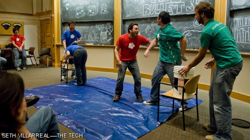 Deepa Mokshagundam ’09, Matt Ciborowski G, and David Brescia (left to right) of Roadkill Buffet — MIT’s improvisational comedy troupe — carry on a conversation where, at all times, at least one person must have their head in a bucket full of water.