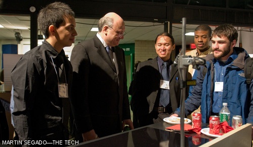 Professor David Wallace PhD ’95 (center) and several members of the Silver Team stand behind the team’s “Infinite Range” prototype following the Product Engineering Process (2.009) final presentations on Monday evening. This cooktop featured a touchscreen interface and an array of 95 independent heating and sensing elements intended to accommodate various pieces of cookware placed at arbitrary locations on its surface.