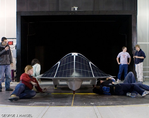 (left to right) David Sanchez ’09, Rachel Batzer ’11, Jessica Lin ’12, Kelly Ran ’12, Alejandro Arambula ’12, Ethan Huwe ’10, and Michael Roberts ’11 put the finishing touches on the Solar Electric Vehicle Team’s car Tuesday morning before a wind tunnel run at Jacobs Sverdrup in Dearborn, Michigan.