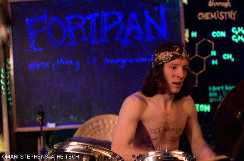 Jon “Okie” Williams ’07 of the carrie okie band (aka Fortran) plays the drums with a “Hello, World” program, written in the Fortran 77 programming language, on his chest. The Bexxxley Roxxx Some More concert, which happened Saturday night in the basement of Bexley Hall, featured a number of MIT student bands.