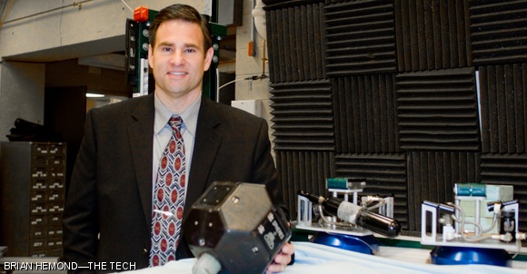 Gregory E. Chamitoff PhD ’92, who recently returned from a 179-day tour of duty aboard the International Space Station as the Flight Engineer and Science Officer for Expedition 17-18, which began June 2, 2008, stands with a miniature satellite that was developed at the MIT Space Systems Laboratory. While aboard the ISS, Chamitoff used these satellites to test hypersonic satellite motion planning algorithms he developed for his PhD thesis. Chamitoff gave a lecture on Tuesday at the Space Systems Laboratory.