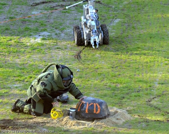A Cambridge Bomb Squad officer attempts to disable a device placed on Kresge Field on the morning of April 24. The device was, in fact, a cherry-bomb-shaped concrete block advertising for this weekend’s annual DTYD party hosted by the Burton 3rd Bombers.