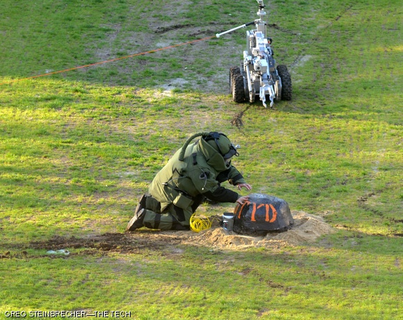 A Cambridge Bomb Squad officer attempts to disable a device placed on Kresge Field on the morning of April 24. The device was, in fact, a cherry-bomb-shaped concrete block advertising for this weekend’s annual DTYD party hosted by the Burton 3rd Bombers.