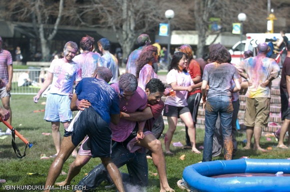 Varun R. Chirravuri ’09 (center) struggles against efforts to toss him into a pool of water during Holi celebrations.