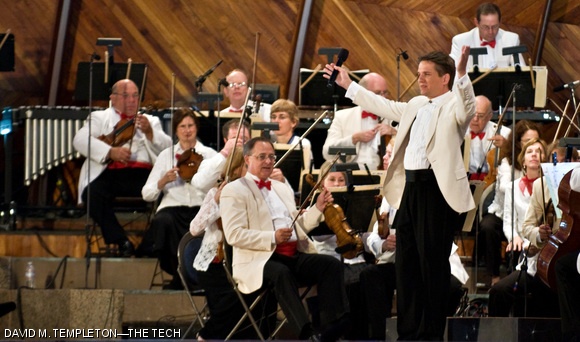 Boston Pops conductor Keith Lockhart gestures to the crowd during the Pop’s public rehearsal on July 3 at the Hatchshell on the Esplanade.