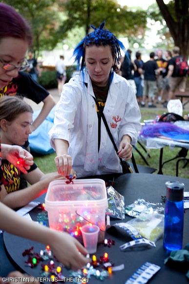 Kendra L. Pugh G grabs an East Campus “burning man” LED “throwie” used as a decoration during REX on Aug. 30.
