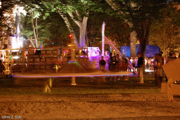 Freshmen and upperclassmen ride a wooden spinning structure in the East Campus courtyard during the East Side Party on Aug. 30. The ride was constructed by dorm residents for REX.
