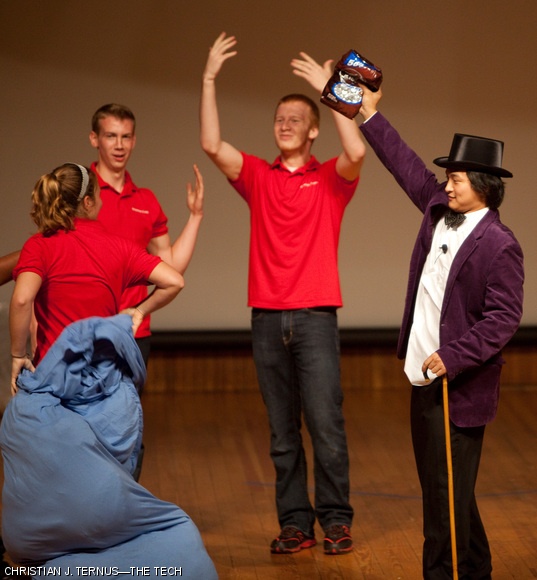 Chao He ’12, dressed as Willy Wonka, announces the victory of the orientation leaders over a group of freshmen in a game involving stuffing a cloth bag with blankets and a person, then rolling the combination down to the finish line. The game was part of the Kickoff! orientation event held Sunday evening in Kresge.