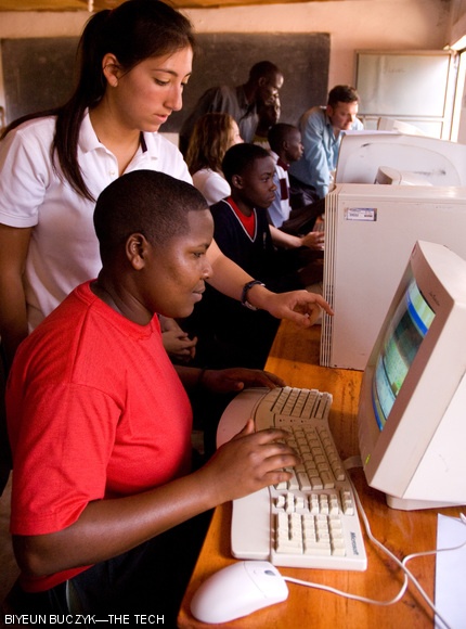 Carolina Hernandez teaches a student from Bwala Secondary School, Uganda how to use a typing tutor. She is part of a group of high students from Seattle, WA and Greenwich, CT who came to Uganda for three weeks in June with the Computers for Uganda organization to set up computer labs in primary and secondary schools there.
