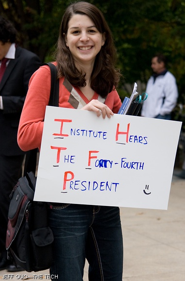 An excited MIT student awaits the arrival of President Obama in front of 77 Mass. Ave on Friday.