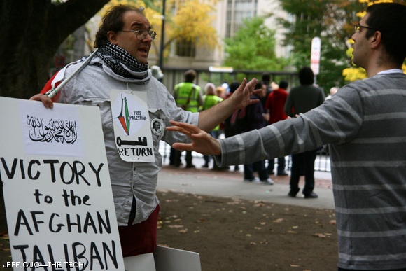 Demonstrators stirred up heated arguments with bystanders on Oct. 23 as they awaited the arrival of President Obama to the MIT campus. This demonstrator had another hand-lettered sign that read “Arrest obama for war crimes.”