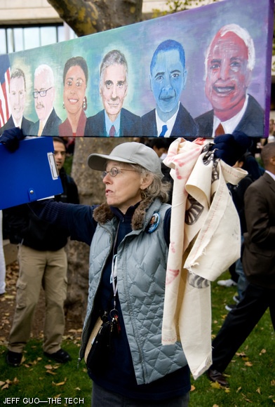 A supporter of Lyndon LaRouche holds up a painting of the 2008 presidential candidates as she awaited the arrival of Obama to the MIT campus on Friday. “Why is Obama blue?” a bystander asked. “You go in there and ask him!” she laughed, pointing toward Kresge.