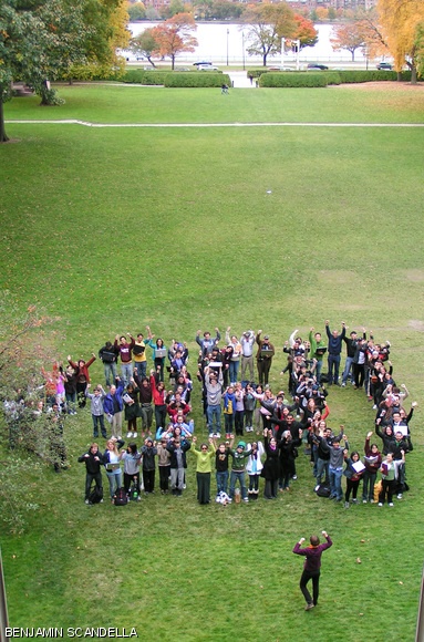 Members of the MIT community assemble in the shape of