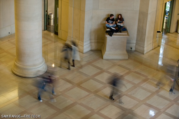 Students sit atop a plinth in the corner of Lobby 7 as pedestrians walk past on Nov. 5. The Class of ’54 will be holding a student contest for designs to sit atop the pedestals, which were left unfinished after Lobby 7 was built in 1939.