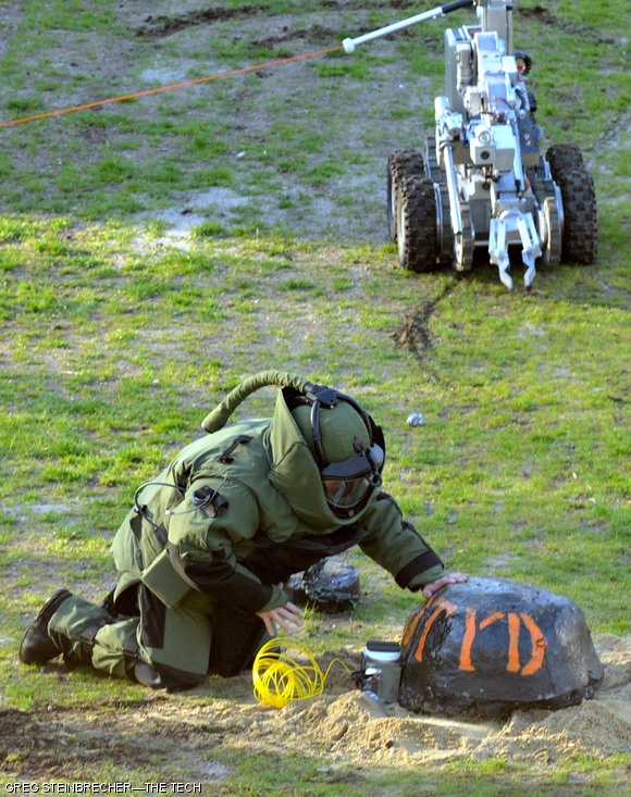 A Cambridge Bomb Squad officer attempts to disable a device placed on Kresge Field on the morning of April 24. The device was, in fact, a cherry-bomb-shaped concrete block advertising for the weekend’s annual “Dance ‘Til You Drop” party hosted by the Burton 3rd Bombers.