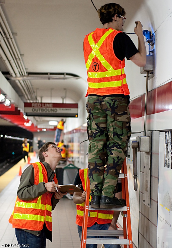 Maxwell Mann ‘12 observes as Nathan Lachenmyer ‘10 works to free the drive chain from the bell at the Kendall Red Line station. The MIT Kendall Band Preservation Society began their work repairing and refurbishing the Paul Matisse musical sculpture yesterday.
