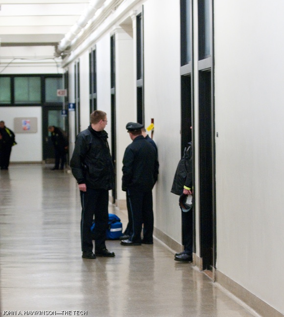 MIT Police examine the area on the first floor of Building 2, where the incident took place.