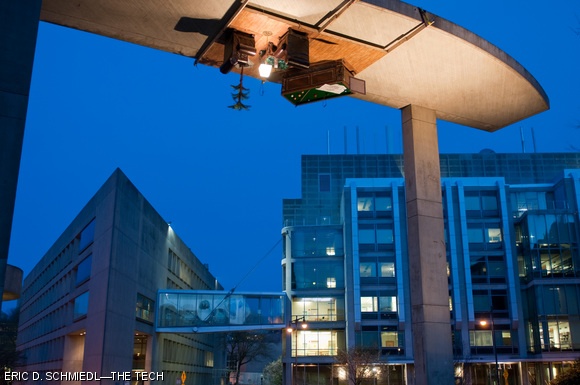 For Campus Preview Weekend 2010, hackers installed a high-class lounge (complete with pool table, sleeping cat, whiskey, and hack plans) upside down on the Media Lab Arch on Thursday morning.