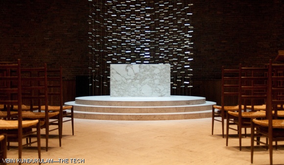 MIT chapel: MIT’s non-denominational chapel, designed by Eero Saarinen, lies across from Kresge Auditorium. The metal sculpture behind the altar catches reflected light from the moat to provide ambient lighting inside.