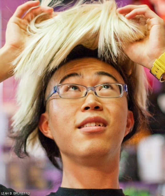 Yu-Pu tries on wigs at Cambridge’s Garment District to complete his Lady Gaga costume for his latest music video.