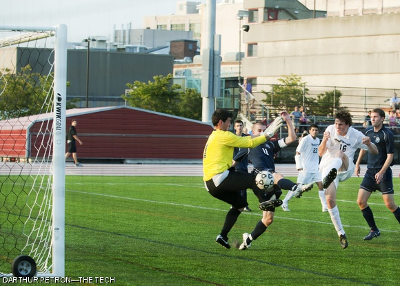 Benjamin A. Lewis ’13 scores in the second quarter against two Brandeis defenders on Wednesday. The Engineers defeated Brandeis 2-1.