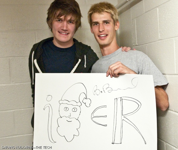 Comedian Robert “Bo” Burnham poses with fan Stephen A. McCrory ’14 (right) after performing in Kresge last Saturday. Stephen surprised the audience during the show with a poster depicting “i times Santa is real,” a line Bo had used a few seconds earlier in one of his songs.