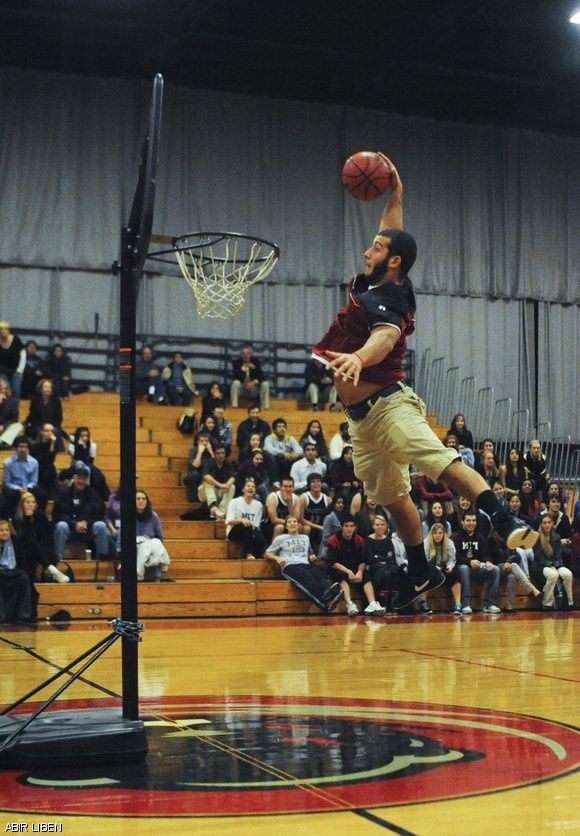 Joel T. Santisteban ’14 soars above the net in the student dunking contest during the 1st annual Beaver Madness rally on Friday, which marked the official start of the basketball season. The men’s team is ranked 18th in the D-III News preseason poll, after finishing last season with a 22-5 record.