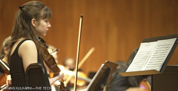 Wellesley student Audrey Wozniak scans her music before the start of Friday’s MITSO performance in Kresge Auditorium.