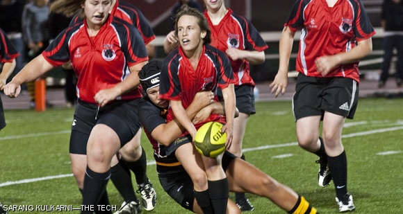 Scrum-half Jacqueline P. Simpson ’14 is tackled while passing the ball to fly-half Stephanie E. Sallum ’12 during the women’s rugby game against Wentworth Institute of Technology on Oct. 9. The Engineers will be playing in the regional semifinals against Middlebury on Briggs Field at 1 p.m. on Saturday.