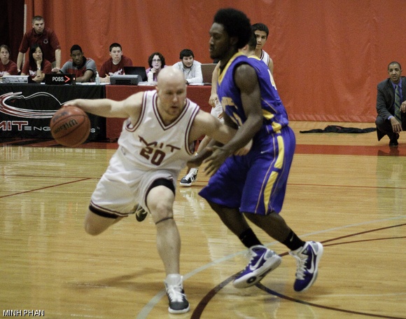 Arni A. Lehto ’12 (#20) tries to drive in against an Emmanuel College defender in the men’s basketball season opener on Tuesday. MIT won 91-61.