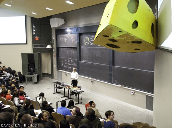 Mysterious hackers managed to hang a very large cheese in 10-250 on Thursday morning, just in time for the final session of 18.02. The cheese is a reference to the fact that the class always says “cheese!” when Professor Bjorn Poonen makes a mistake in lecture.