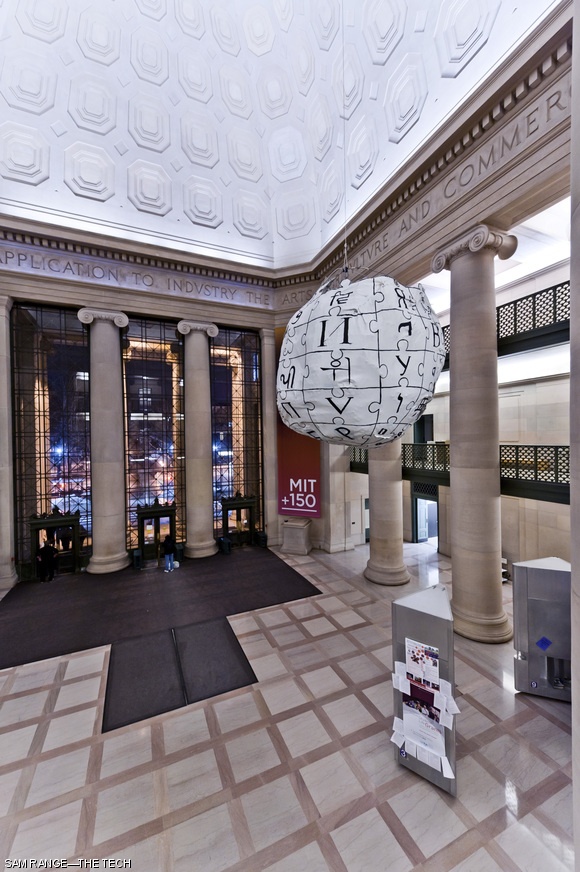 In celebration of Wikipedia’s tenth birthday, hackers installed a suspended globe of puzzle pieces, modeled after the online encyclopedia’s logo, in Lobby 7. Wikipedia’s logo, used since 2003, is an incomplete puzzle composed of pieces bearing characters from various languages.