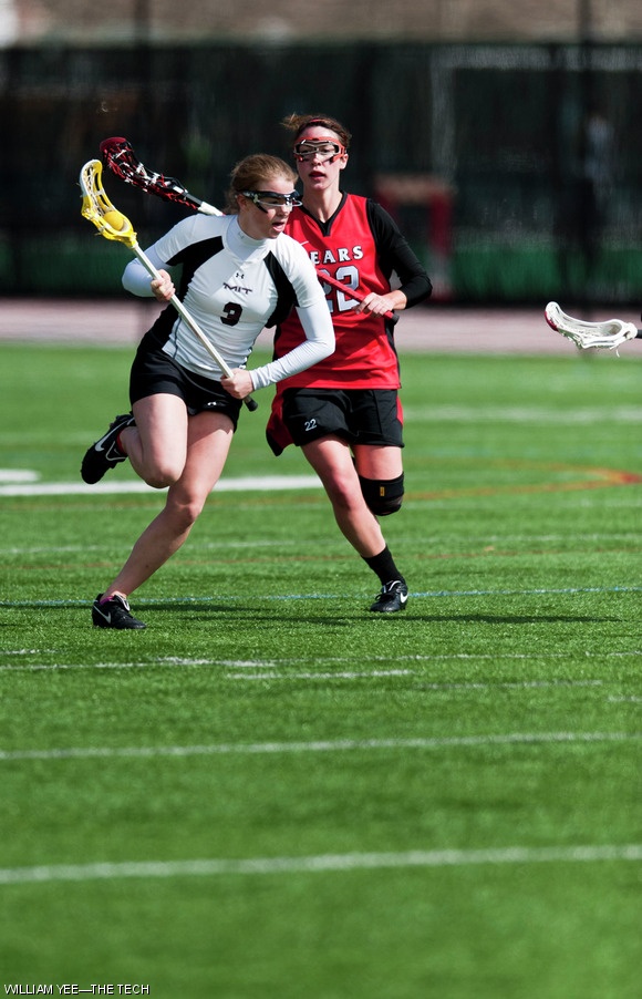 Laura M. Wacker ‘13 rushes toward the goal under pressure from Bridgewater State lacrosse players on Saturday, March 12. The Engineers lost 9-8.