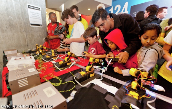 Children learn the inner workings of a joystick-controlled robotic manipulator during a technology demonstration at the Stata Center during MIT’s Under The Dome open house celebration on Saturday afternoon. Approximately 20,000 attendees visited campus for the first open house in over 30 years, part of MIT’s 150th anniversary celebrations. For more photos of Under The Dome, see p. 11.