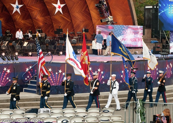 The honor guard displays flags before the beginning of the concert.