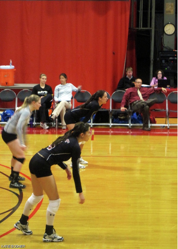 Natasha H. Jensen ’12 (near), Katie K. Spielbauer ’13 (middle), and Trinity P. Leonard ’13 (far) await the return of the ball during Tuesday night’s volleyball game.